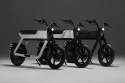 A set of three e-motorbikes painted in black, white and gray.